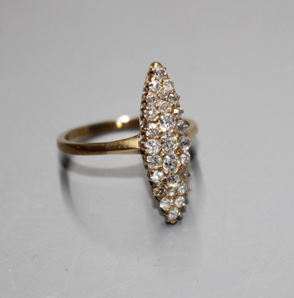 A yellow metal (tests as 18ct) and old round cut diamond set marquise cluster ring,